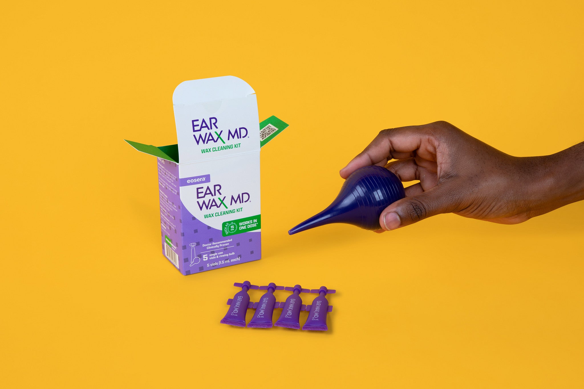 Ear cleaning kit with 'Ear Wax MD' packaging on a yellow background