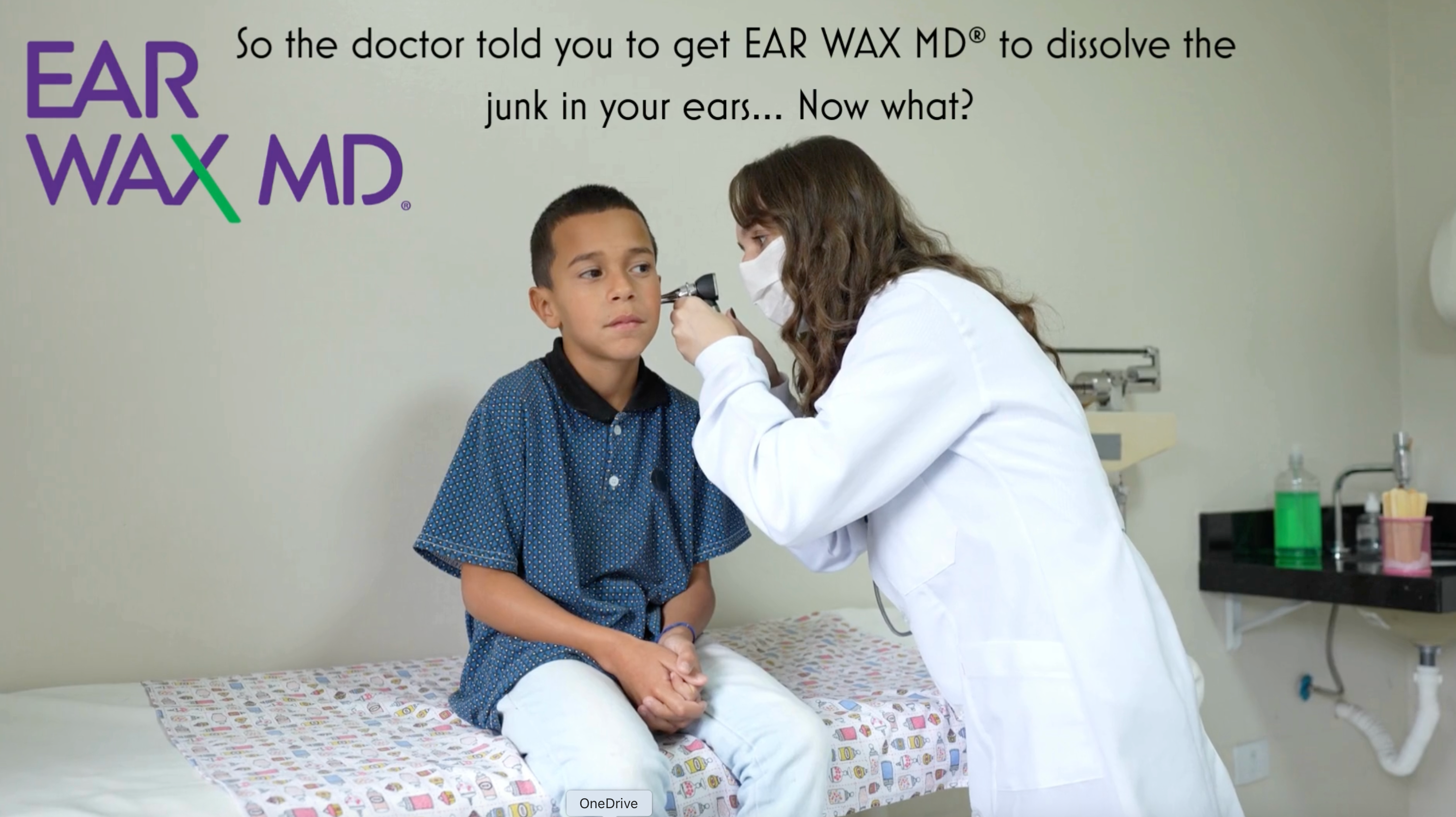 Doctor examining a child's ear with Ear Wax MD product visible