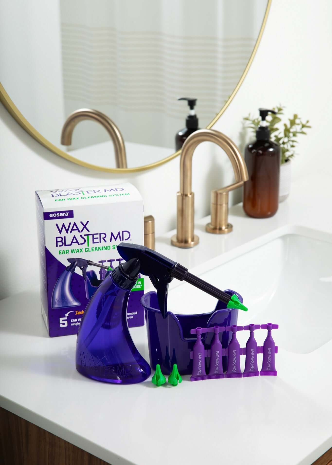 Wax Blaster MD ear wax cleaning kit displayed on a bathroom sink with sprayer and replacement tips.