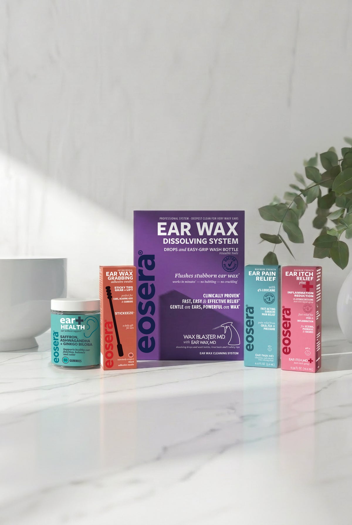 eosera ear care products on a marble surface with a plant in the background