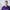 Medical professional in purple scrubs discussing health topics with a stethoscope around his neck.